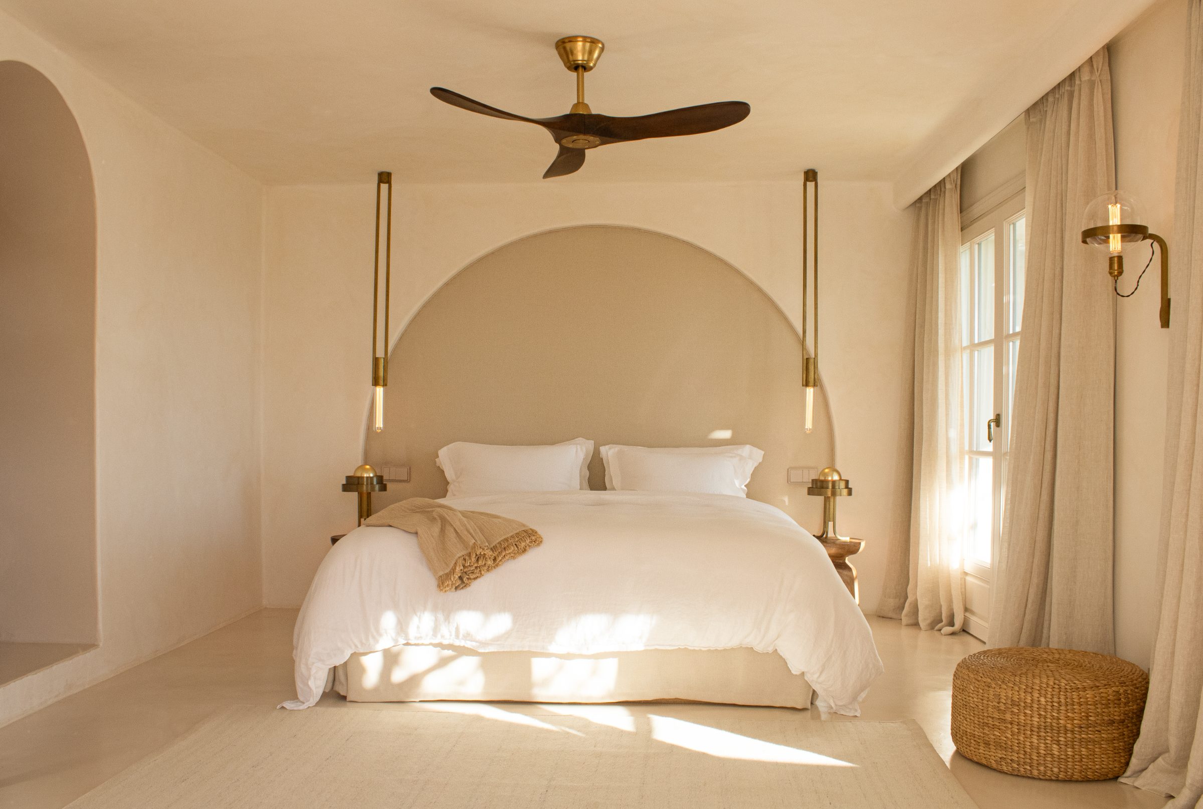 Room Lasya — arch headboard, white linen, brass pendants